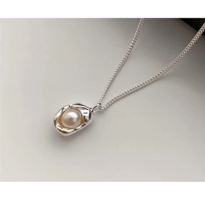 Detailed view of S925 silver necklace with irregular molten metal and white pearl charm