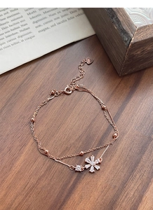Detail of rose gold S925 silver double-layer bracelet with snowflake pendant and beads