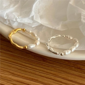 Detailed shot of gold and silver S925 sterling silver rings with freshwater pearls