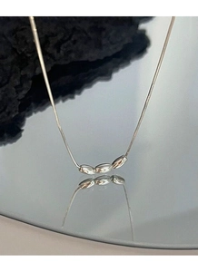 Detail view of S925 silver necklace with three polished oval beads on a minimalist chain