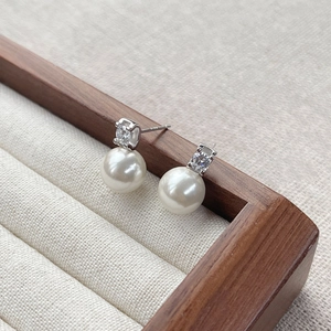 Elegant S925 sterling silver pearl stud earrings with zircon in a wooden jewelry box