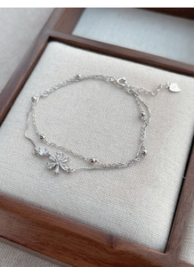 Detail view of S925 sterling silver double-layer bracelet with sparkling zircon cherry blossoms