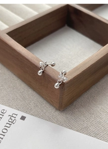 Macro detail of S925 sterling silver bow knot stud earrings with screw back design