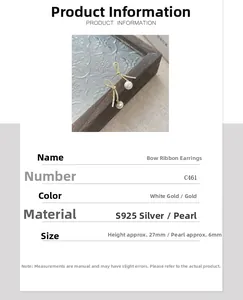 Detailed close-up of S925 silver bow ribbon earrings with white pearl on glass tray