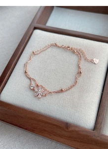 Detail of rose gold S925 silver double-layer bracelet with sparkling zircon flowers