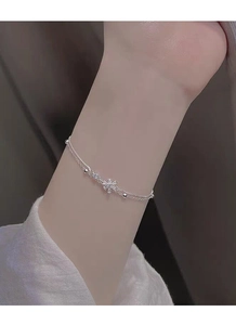 Detail of a S925 silver double-layer bracelet featuring a snowflake zircon pendant