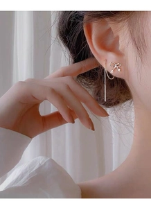 Elegant S925 silver bow tassel earrings with zircon accents worn by a model
