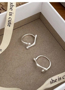 Detail of irregular S925 sterling silver ball rings in a minimalist white gift box