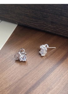 Macro view of S925 sterling silver bow earrings with round brilliant cut cubic zirconia