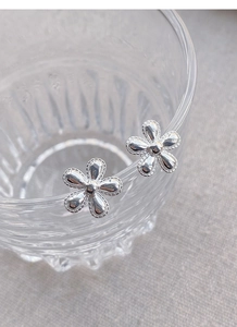 Close-up of S925 sterling silver sunflower stud earrings with beaded petal edges