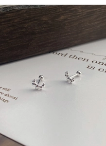 Macro detail of S925 sterling silver curved bead studs with secure screw back closure