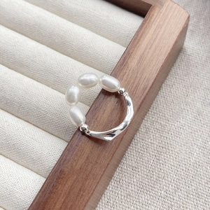 S925 sterling silver ring with four natural freshwater pearls in a wavy band design