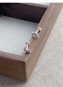 Macro view of S925 sterling silver curved bead earrings with secure screw-on ball backings