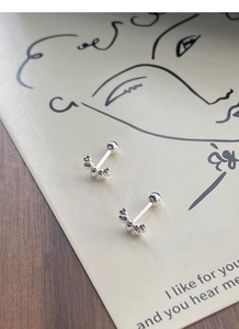 Macro detail of S925 sterling silver beaded crescent stud earrings with screw back ball