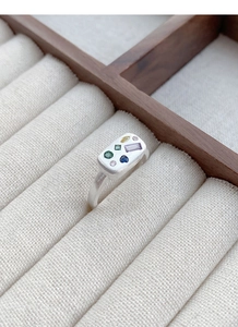 Detailed close-up of S925 sterling silver ring with multi-colored gemstones in matte finish