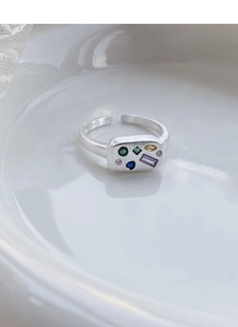 Macro shot of S925 sterling silver ring showing brushed texture and colorful zircons