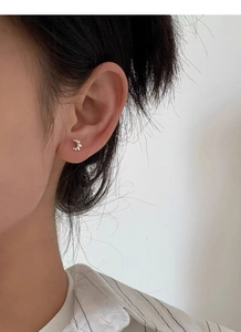 Close-up of S925 silver croissant stud earring on ear with screw back detail