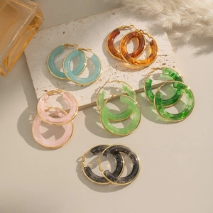 Fashion resin hoop earrings with gold metal frame in various colors on stone pedestals