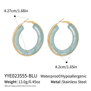Detail view of light blue resin hoop earrings with stainless steel gold accents and size specs