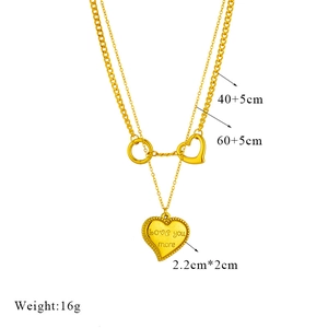 Detail of layered gold-plated chain necklace with engraved heart Love You More pendant