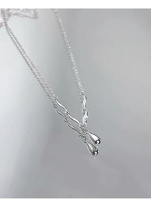 Detailed macro view of S925 sterling silver water drop pendant and liquid metal chain links