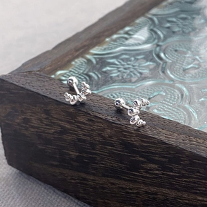 Minimalist S925 silver croissant stud earrings with screw ball backs on vintage wood
