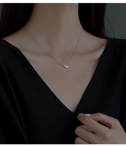 Detail of S925 sterling silver star pendant necklace worn by a model on collarbone