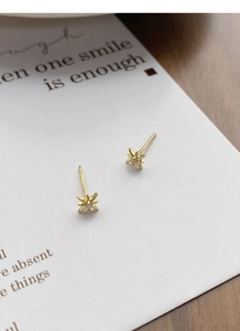 Detail of S925 hallmark on gold-plated star stud earrings with central zircon