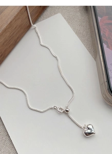 Detailed view of polished S925 sterling silver heart necklace with adjustable chain