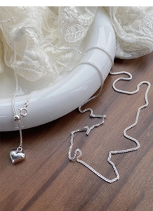 Detailed view of S925 sterling silver heart pendant with adjustable sliding bead clasp