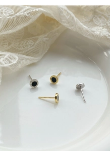 Macro view of S999 sterling silver stud earrings with Roman numerals and black inlay