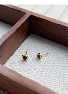 Detailed macro of S999 silver earrings with Roman numerals and black enamel inlay