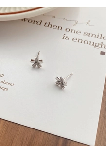 Macro shot of S999 sterling silver cherry blossom stud earrings with pavé set zirconia