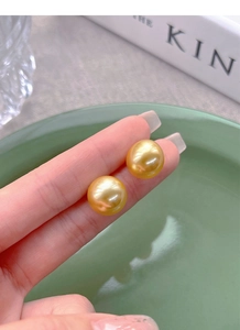 Macro shot of high-quality large round golden pearls with mirror-like metallic luster