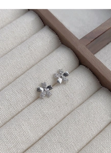 Macro shot of silver cherry blossom stud earrings featuring sparkling cubic zirconia stones