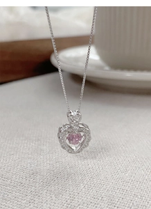 Detailed macro view of S925 sterling silver heart necklace with a dancing pink zircon stone