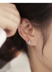 Close-up of S999 sterling silver cherry blossom stud earrings with sparkling crystals