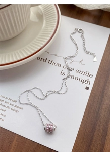 Close-up of S925 sterling silver necklace with pink zircon waist-shaped pendant
