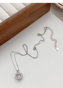 Detail of S925 sterling silver heart necklace with pink stone and white diamonds