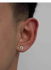 Close-up of S999 silver Roman numeral stud earring with black inlay on male model ear
