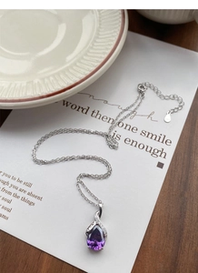 Detailed macro of S925 sterling silver stamp on the purple teardrop pendant necklace