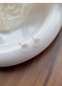 Macro shot of S925 sterling silver camellia earrings with iridescent resin petals