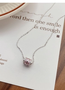 Detail of S925 silver cylinder necklace with pink zircon inlay and white diamonds