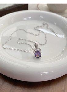 Macro shot of S925 sterling silver necklace featuring a pear-cut purple gemstone pendant