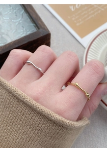 S925 silver irregular textured rings in gold and silver set on a model with knitwear