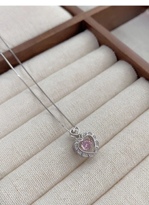 Detail of S925 silver heart necklace featuring a pink gemstone and diamond-set petals
