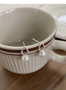 Detail of S925 sterling silver irregular geometric earrings with elegant white faux pearls