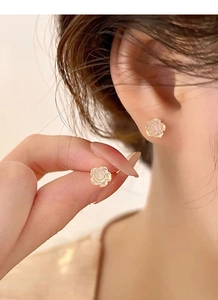 Close-up of S925 silver flower stud earrings with iridescent layered petals detail
