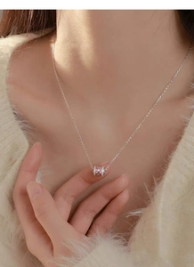 Detail of S925 sterling silver cylinder necklace with pink and white crystals on neck