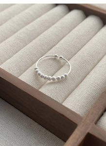 Detail of 925 sterling silver beaded ring with 10 frosted metal beads on an open band